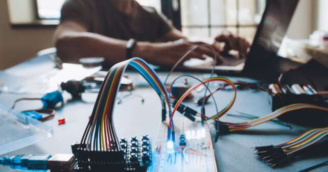 Schmuckbild Student, der in an einem elektronischen Versuchsaufbau arbeitet